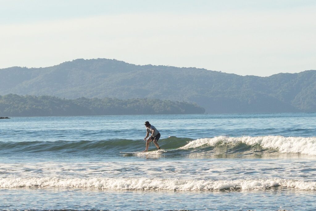 Waluaa retreat guest riding a small green wave in Santa Catalina, Panama